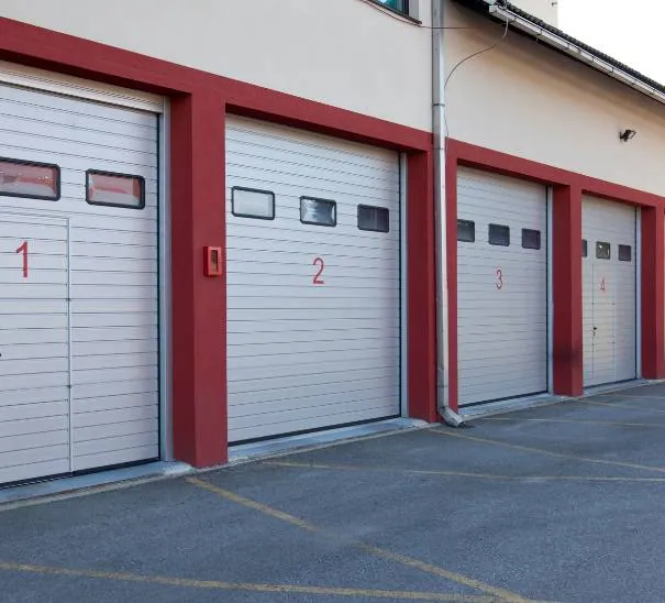 Row of commercial roll-up garage doors serviced by Top Doors