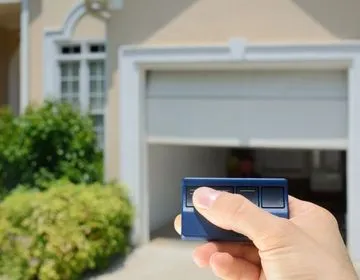 Homeowner operating a garage door opener remote