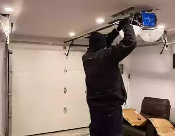 Garage door torsion spring replacement in progress